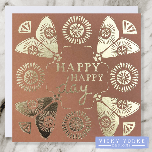 Tan and gold foil greetings card with 'Happy Happy Day' sentiment, with a moth illustration in each corner and sunshine decoration.