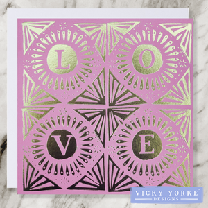 Pink and gold foil greetings card featuring bold hand lettering 'love' and hand drawn geometric decoration. 