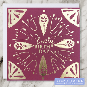 Burgundy and gold foil greetings card with 'Lovely Birthday' sentiment and abstract floral and geometric decoration.
